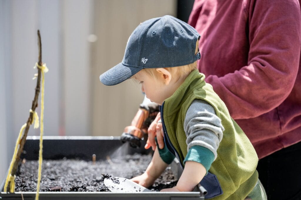 a person and a child working on a piece of metal