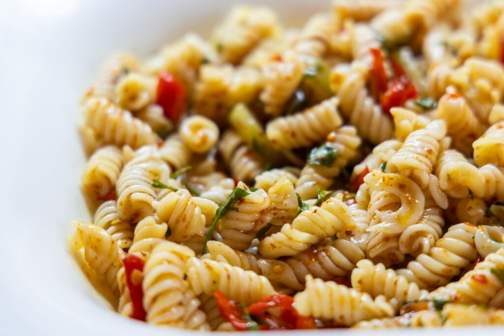 pasta dish on white ceramic bowl, Creative Ways to Repurpose Leftovers Into New Meals