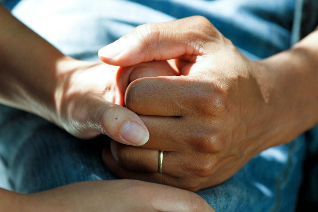 person wearing gold wedding band, Big Family Life Tips