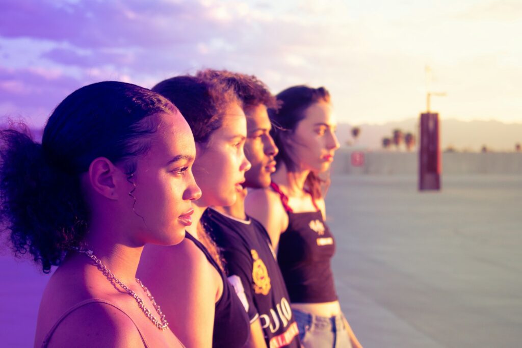 four women standing on pathway looking side, harmonious family relationships