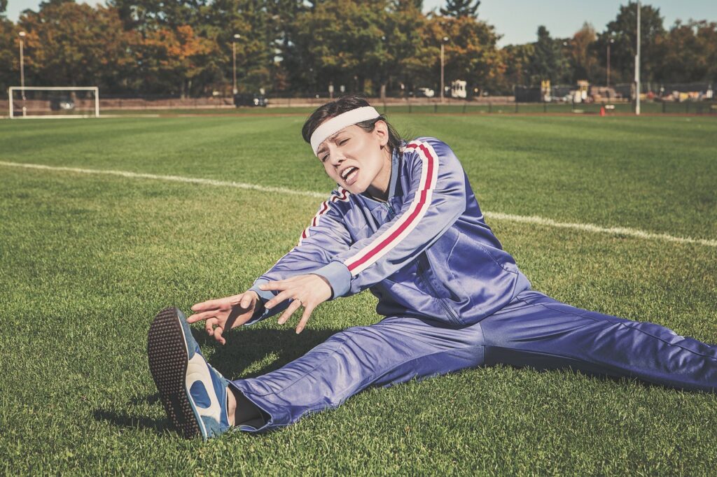 stretching, sports, woman, athlete, fitness, sport, healthy, exercise, workout, young, female, body, lifestyle, training, fit, health, stretch, people, active, girl, adult, person, sportswear, athletic, gym, exercising, physical, sporty, white, pilates, leisure, nature, tracksuit, track and field, shoes, headband, grass, field. Fitness and Aging: A Dad's Guide to Staying Strong After 40